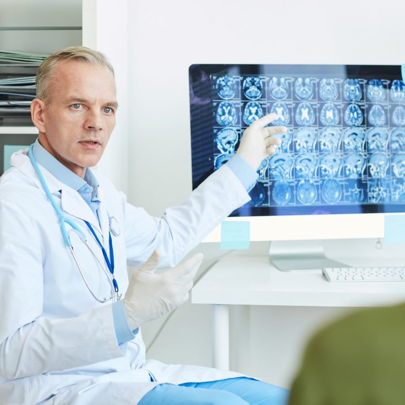 neurologist explaining brain scans MKUFTXV min