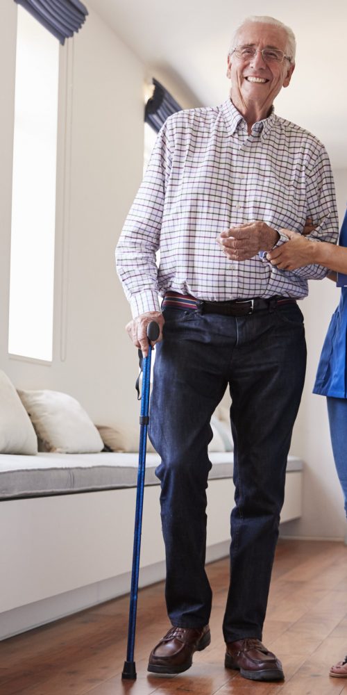 nurse helping senior man walk using a walking stic 2021 08 26 16 13 54 utc min