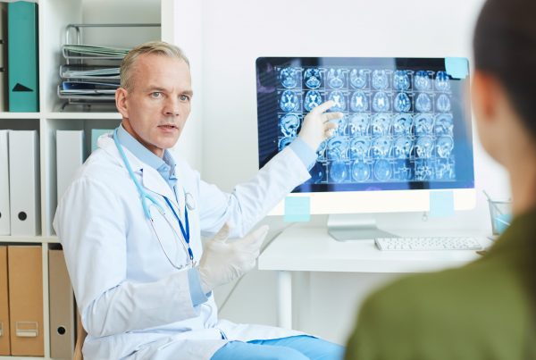 neurologist explaining brain scans MKUFTXV min