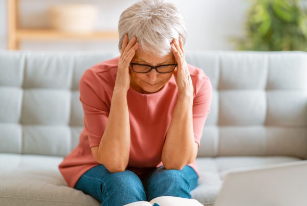 senior exhausted woman having headache 3UGNY5P min