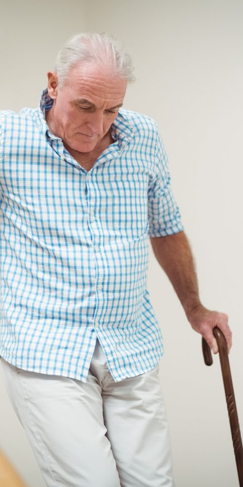 senior man climbing downstairs with walking stick 2021 08 28 22 11 53 utc min