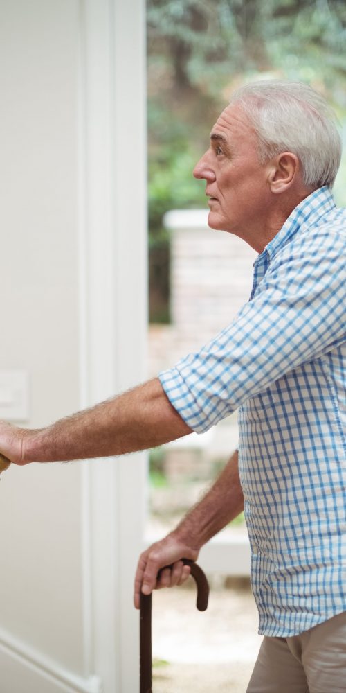 senior man climbing upstairs with walking stick 2021 08 28 16 44 35 utc min