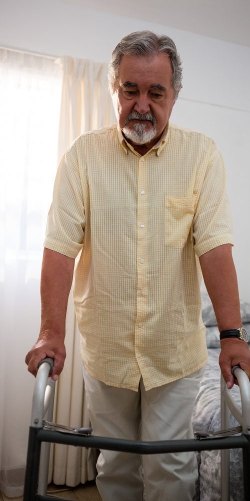 senior man walking with walker at nursing home 2021 08 28 16 46 26 utc min