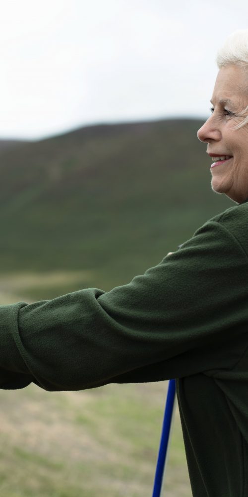 senior woman walking with trekking poles 2022 02 10 06 34 56 utc min
